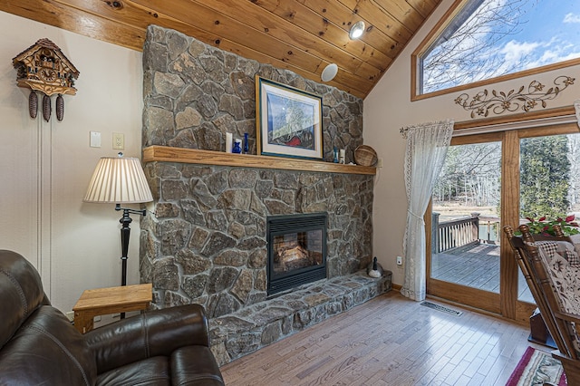 living room with high vaulted ceiling, hardwood / wood-style floors, wood ceiling, and a fireplace