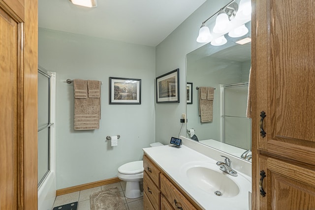 full bathroom featuring vanity, combined bath / shower with glass door, tile patterned floors, and toilet