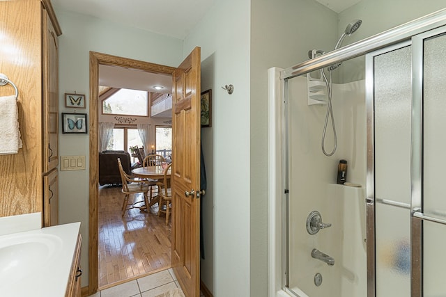 bathroom with vanity, tile patterned flooring, and bath / shower combo with glass door