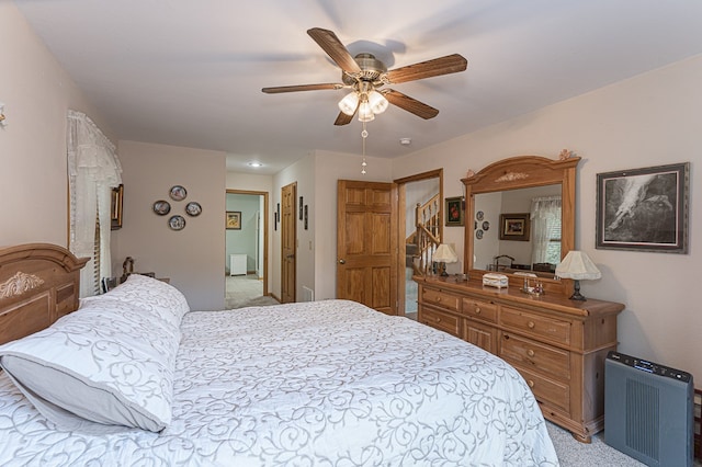 bedroom featuring light colored carpet and ceiling fan