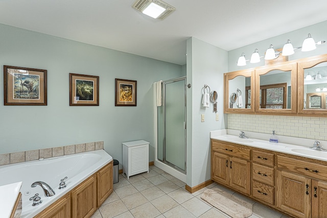 bathroom with tasteful backsplash, vanity, tile patterned flooring, and plus walk in shower