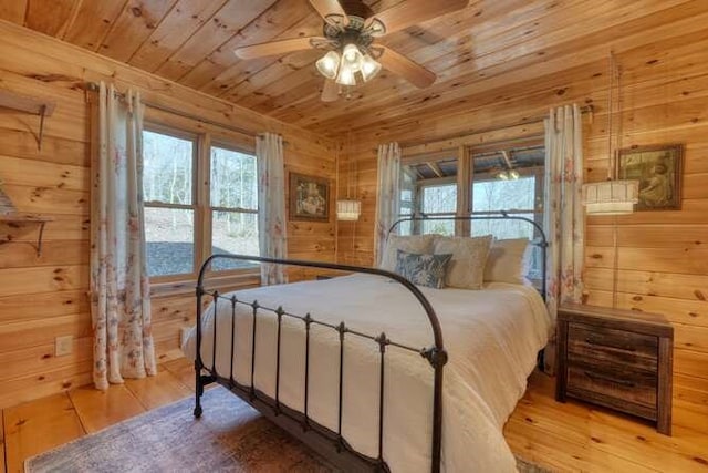 271 Kates Cove Rd, Murphy, NC 28906 - bedroom with wooden ceiling, wooden walls, multiple windows, wood finished floors, and ceiling fan