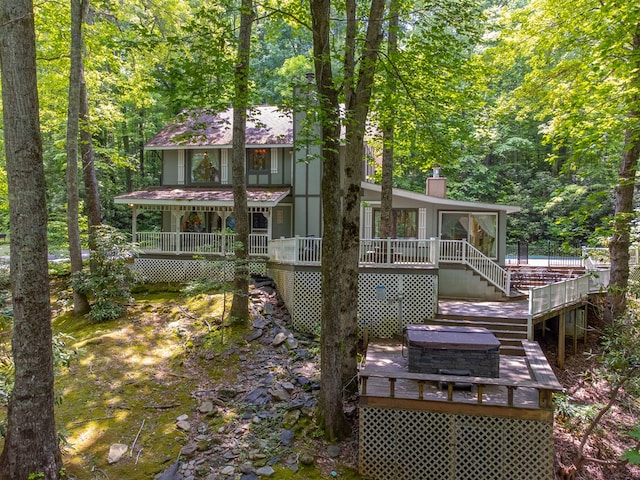 1504 Red Marble Rd, Andrews, NC 28901 - back of property featuring a sunroom, a deck, a chimney, stairway, and a wooded view
