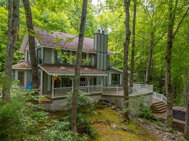 1504 Red Marble Rd, Andrews, NC 28901 - rear view of house featuring a chimney, stucco siding, roof with shingles, and a view of trees