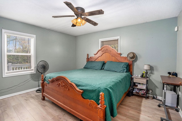 542 Sharp Top Cir, Blairsville, GA 30512 - bedroom featuring wood finished floors, a ceiling fan, and baseboards
