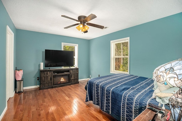 542 Sharp Top Cir, Blairsville, GA 30512 - bedroom with baseboards, a textured ceiling, hardwood / wood-style flooring, and ceiling fan
