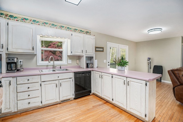 542 Sharp Top Cir, Blairsville, GA 30512 - kitchen featuring black dishwasher, light countertops, a peninsula, and a sink