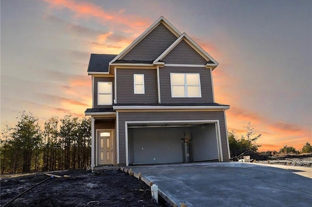 view of front of home with driveway and a garage