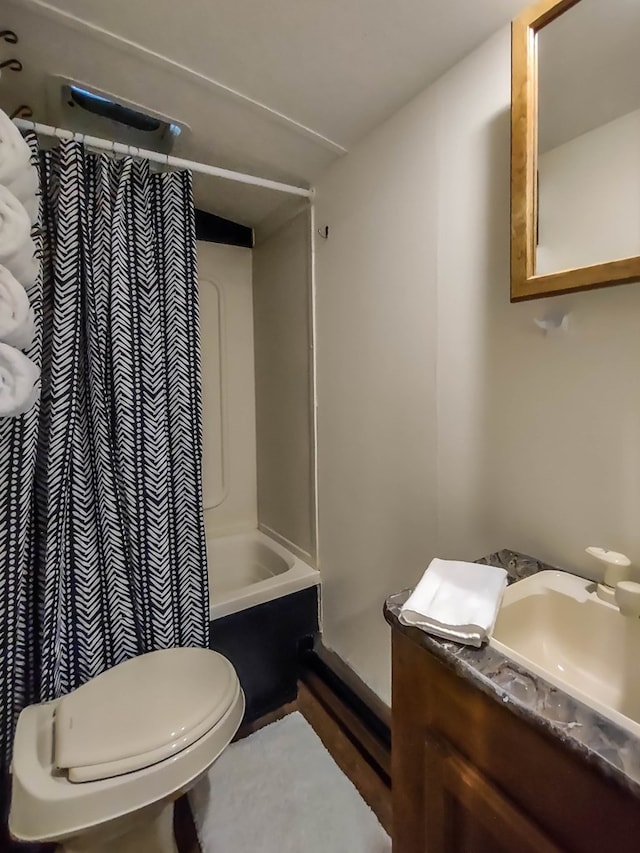 full bathroom featuring toilet, vanity, and shower / bathtub combination with curtain