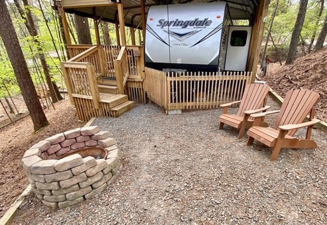 exterior space with an outdoor fire pit and a deck