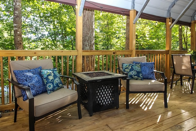 deck with a gazebo and an outdoor living space with a fire pit