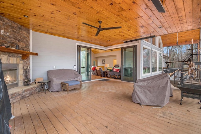 deck featuring a stone fireplace