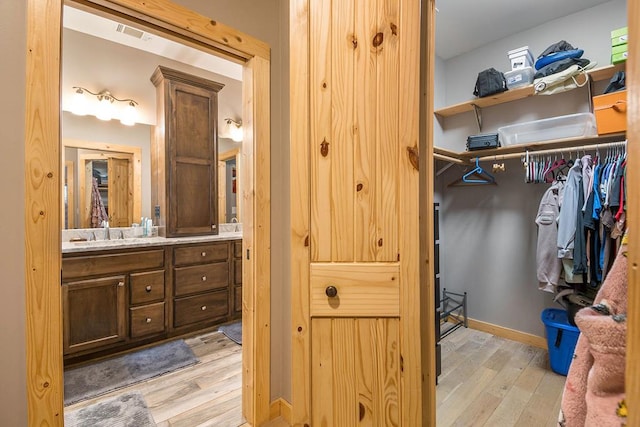 bathroom with vanity and wood-type flooring