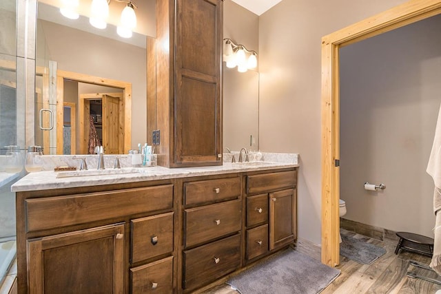 bathroom with vanity, wood-type flooring, and toilet