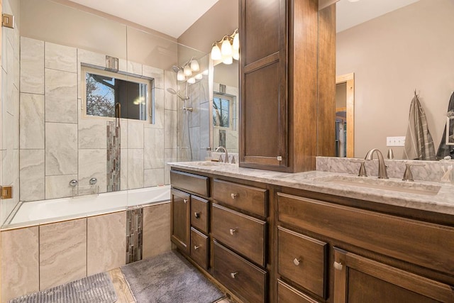 bathroom featuring vanity and tiled shower / bath combo