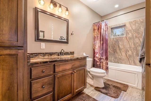 full bathroom featuring hardwood / wood-style floors, vanity, shower / bath combo, and toilet