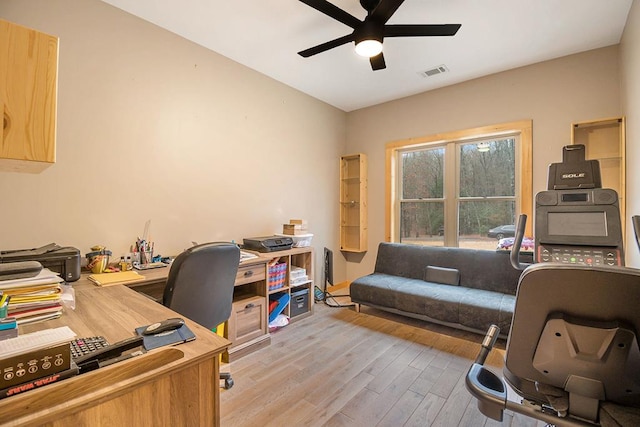 home office with ceiling fan and light hardwood / wood-style floors