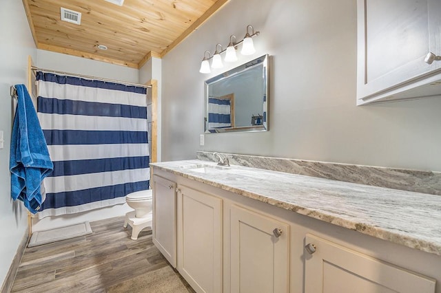 bathroom featuring hardwood / wood-style floors, vanity, a shower with curtain, toilet, and wood ceiling