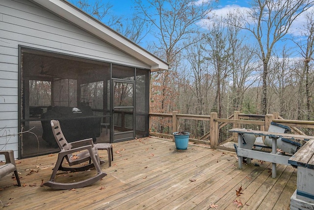 wooden deck with a sunroom