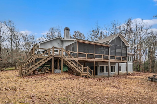 back of house with a wooden deck and a sunroom