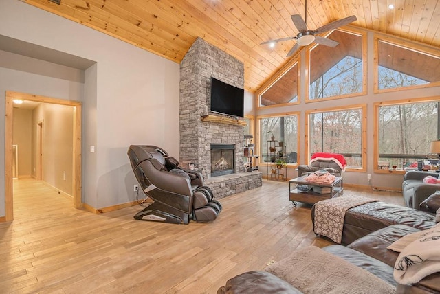 living room with a fireplace, light wood-type flooring, ceiling fan, and wood ceiling