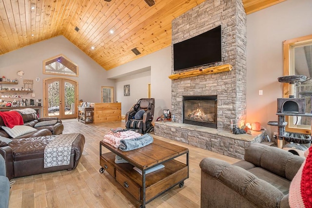 living room featuring french doors, wood ceiling, high vaulted ceiling, light hardwood / wood-style flooring, and a fireplace