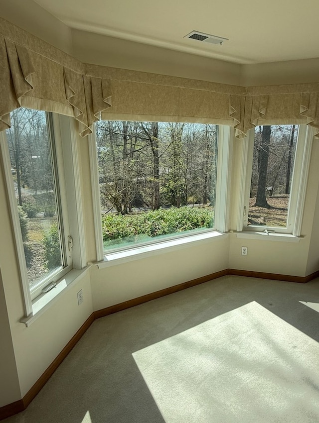 unfurnished sunroom with plenty of natural light and visible vents