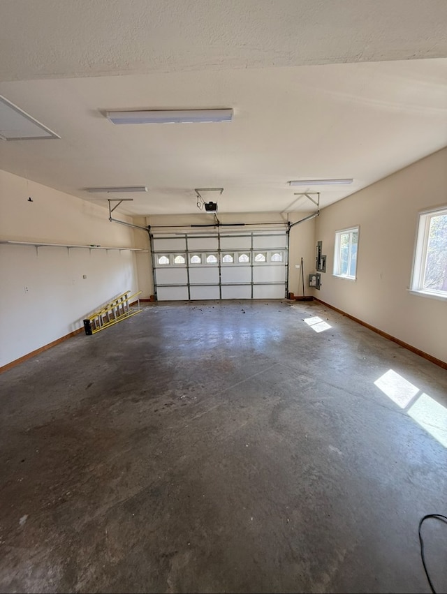 garage with baseboards and a garage door opener