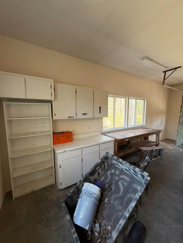 kitchen featuring white cabinets, concrete floors, and light countertops