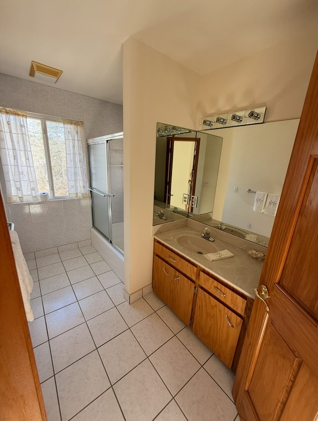 bathroom featuring tile patterned floors, vanity, and an enclosed shower