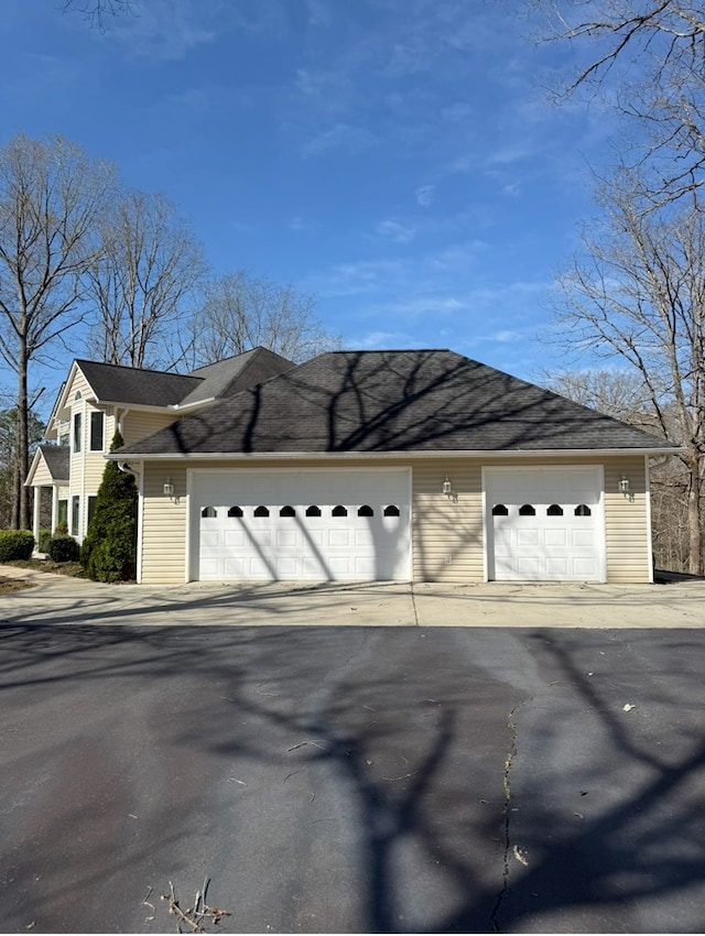 view of property exterior with an outbuilding