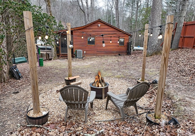 view of yard featuring central AC unit and a fire pit