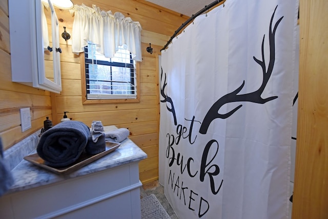 bathroom with wooden walls and vanity