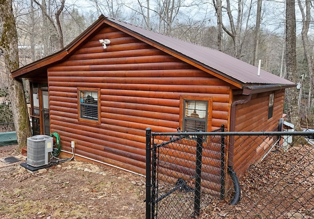 view of side of home featuring central AC