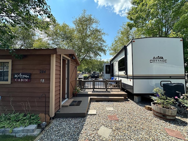 view of side of home featuring a wooden deck