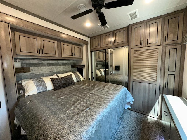 carpeted bedroom featuring ceiling fan and a closet