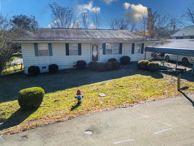 single story home featuring a front yard and a carport