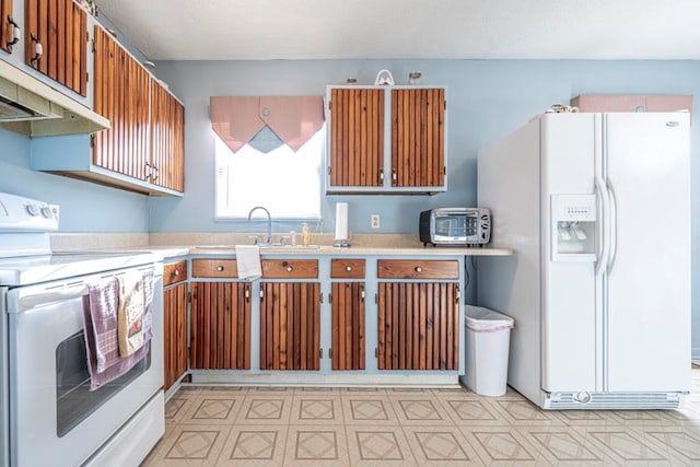 kitchen with sink and white appliances