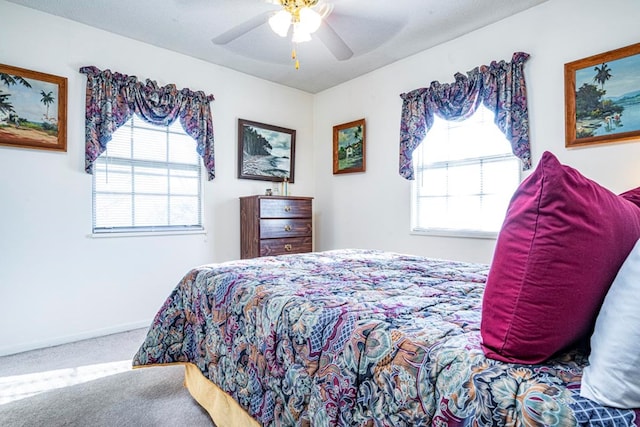 bedroom with carpet flooring, a textured ceiling, and ceiling fan