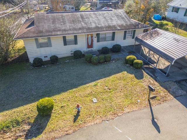 ranch-style home with a carport and a front yard