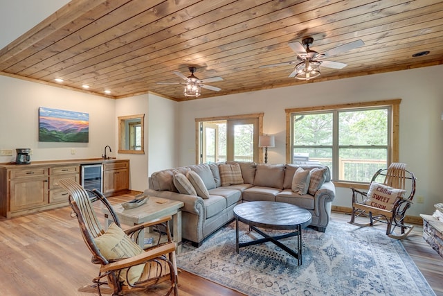 living area with a wealth of natural light, wine cooler, wooden ceiling, and light wood-style floors