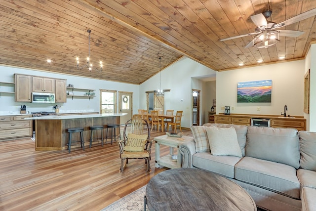 living area with lofted ceiling, wooden ceiling, beverage cooler, and light wood finished floors