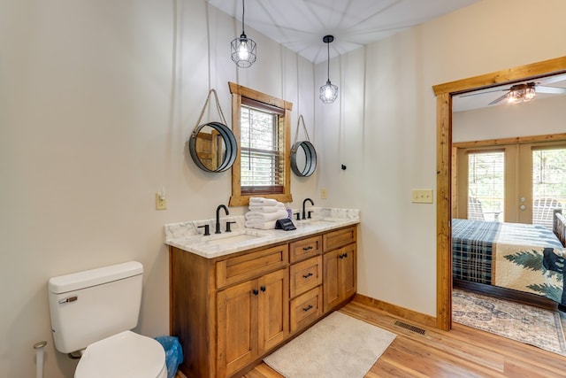 full bath with ensuite bathroom, wood finished floors, a sink, and visible vents