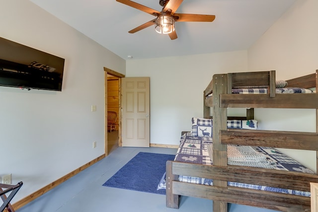 bedroom featuring concrete floors and baseboards