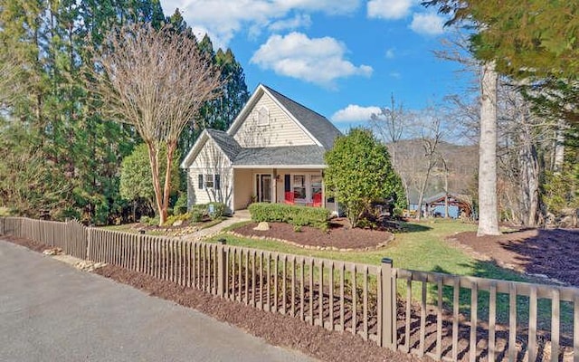 view of front of property with covered porch and a fenced front yard