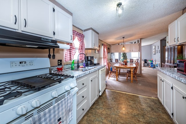 kitchen with white appliances, exhaust hood, sink, hanging light fixtures, and white cabinetry