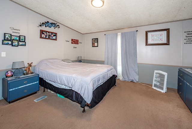 carpeted bedroom with crown molding and a textured ceiling