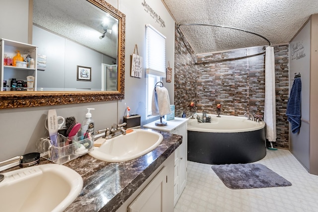 bathroom featuring vanity, independent shower and bath, and a textured ceiling