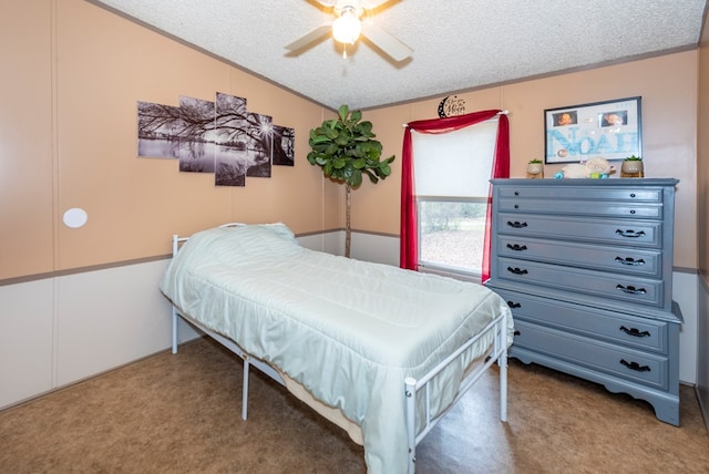 carpeted bedroom with ceiling fan and a textured ceiling