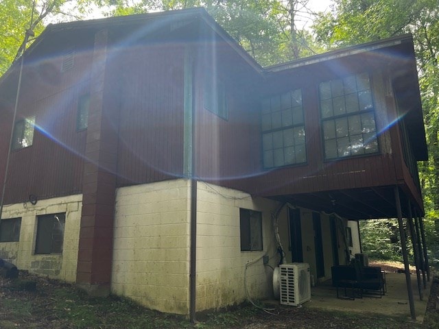 exterior space with a patio area and ac unit